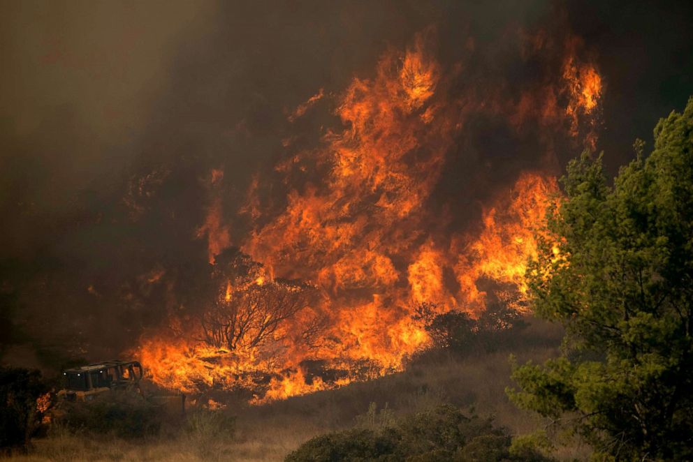 PHOTO: A firefighting bulldozer battles the Bond Fire wildfire near Lake Irvine in Orange County, California, Dec. 3, 2020.