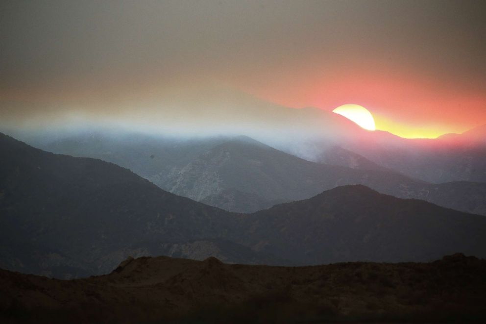 PHOTO: The sun sets behind smoke from the Holy Fire in Cleveland National Forest, Aug. 8, 2018 in Corona, Calif.