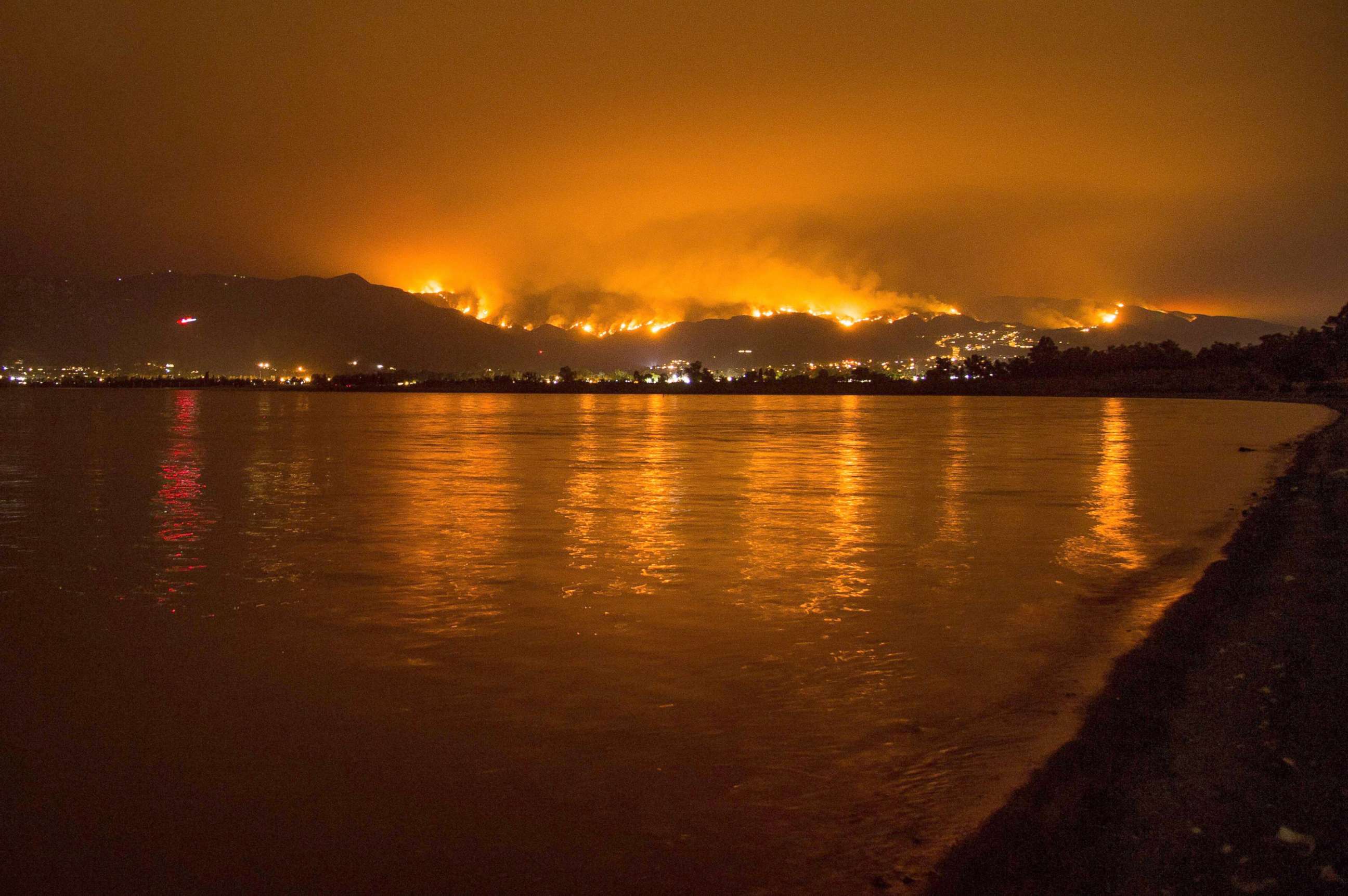 PHOTO: Flames from the Holy Fire are reflected in Lake Elsinore as the wildfire burns in the Cleveland National Forest, in Lake Elsinore, Calif., Aug. 8, 2018.