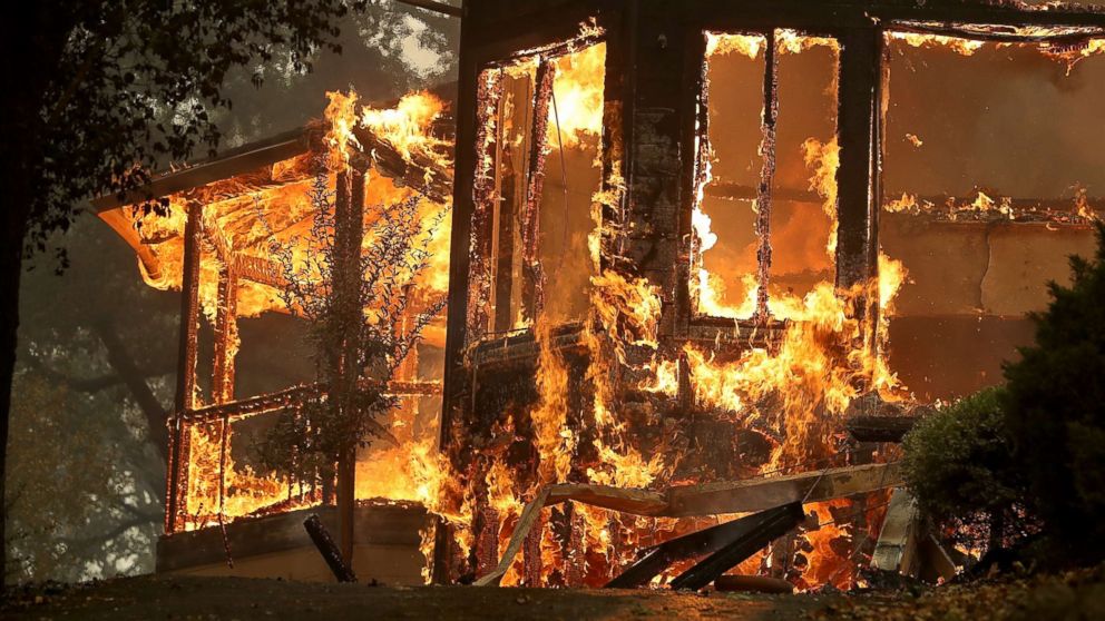 Flames consume a home as an out of control wildfire moves through the area, Oct. 9, 2017, in Glen Ellen, California.