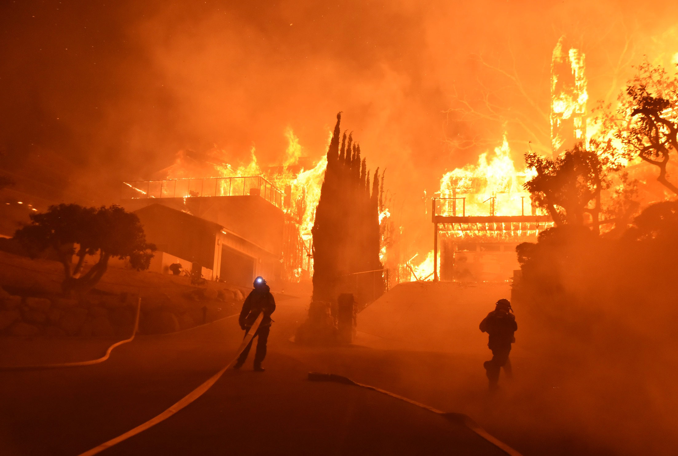 PHOTO: Firefighters work to put out a blaze burning homes early on Dec. 5, 2017, in Ventura, Calif. Authorities said the blaze broke out Monday and grew wildly in the hours that followed, consuming vegetation that hasn't burned in decades.