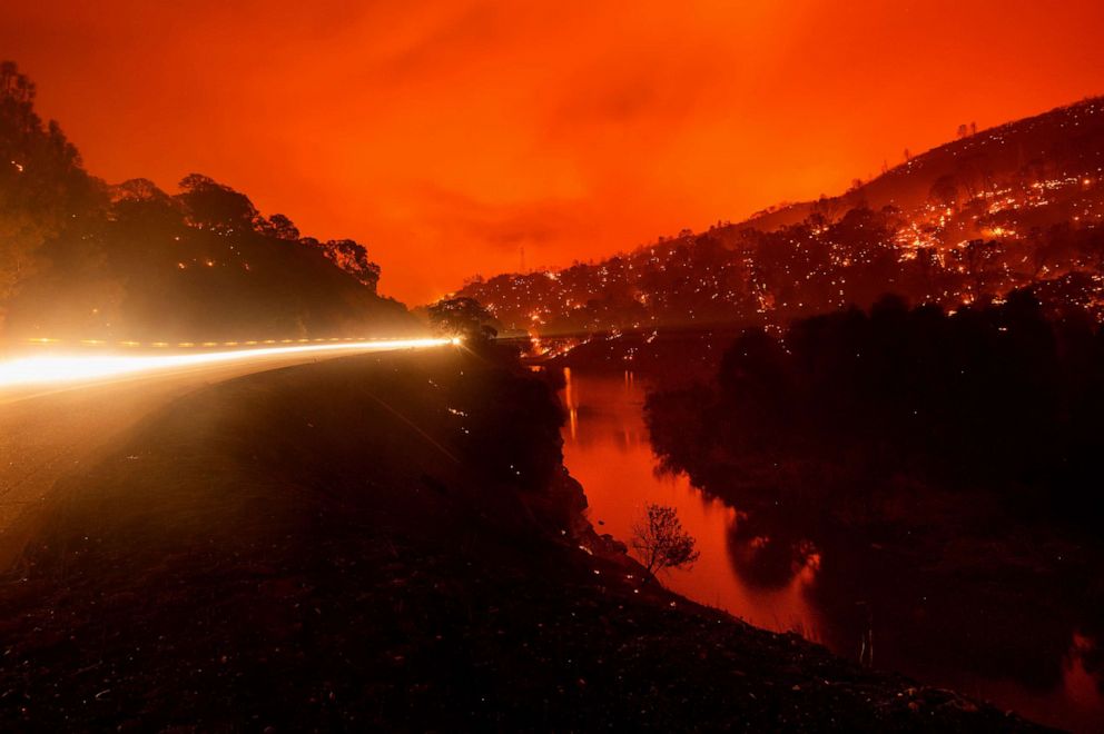 PHOTO: Seen in a long exposure photograph, embers burn along a hillside above Lake Berryessa as the LNU Lightning Complex fires tear through unincorporated Napa County, Calif., Aug. 18, 2020.