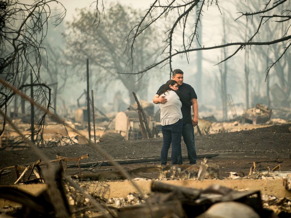 PHOTO: Gabriel Castillo and wife Alea Kelleher embrace while sifting through the remains of their home in Santa Rosa, Calif., Oct. 10, 2017.