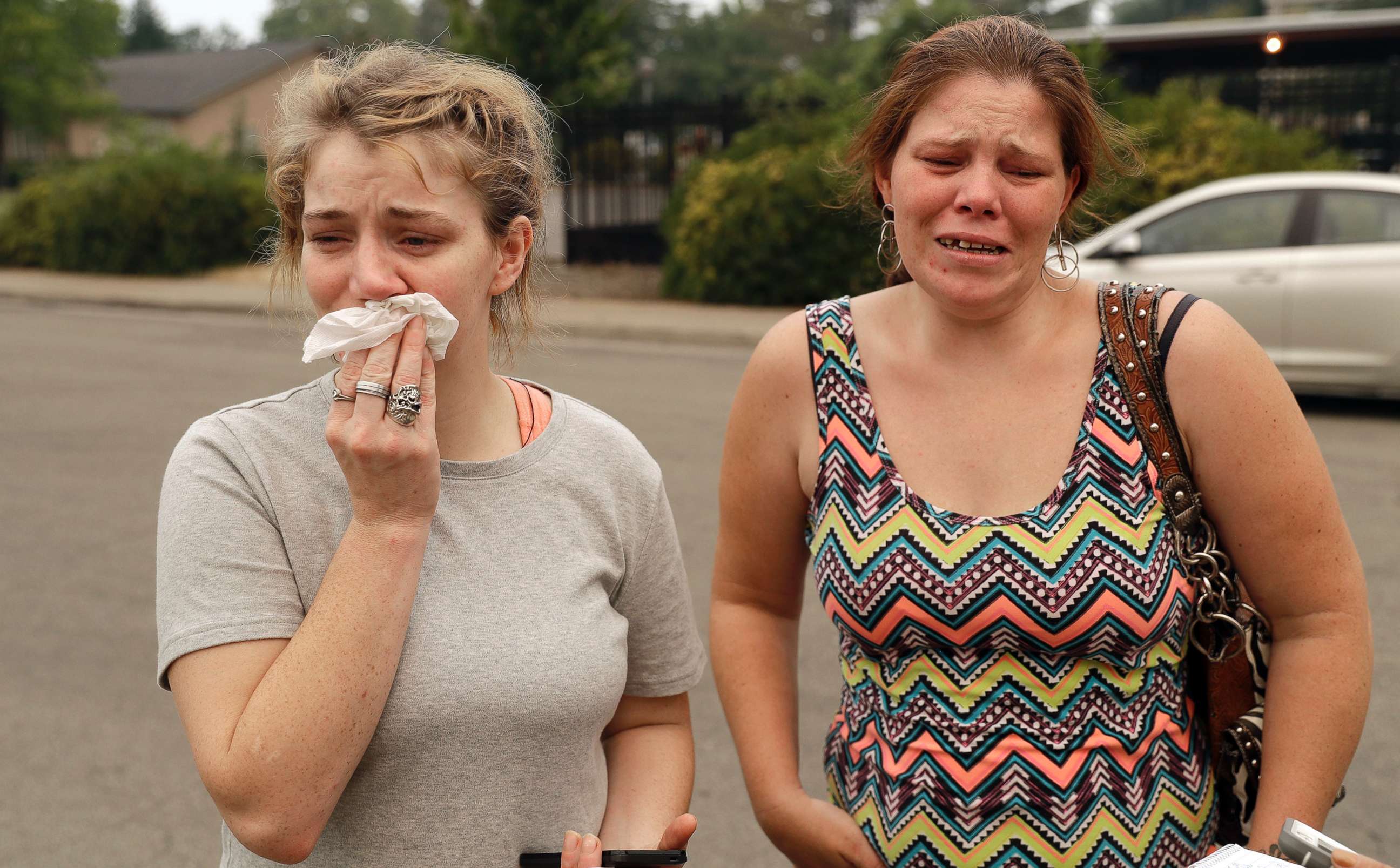 PHOTO: Sherry Bledsoe, left, cries next to her sister, Carla, outside of the sheriff's office after hearing news that Sherry's children, James and Emily, and grandmother, Melody Bledsoe, were killed in a wildfire, July 28, 2018, in Redding, Calif.