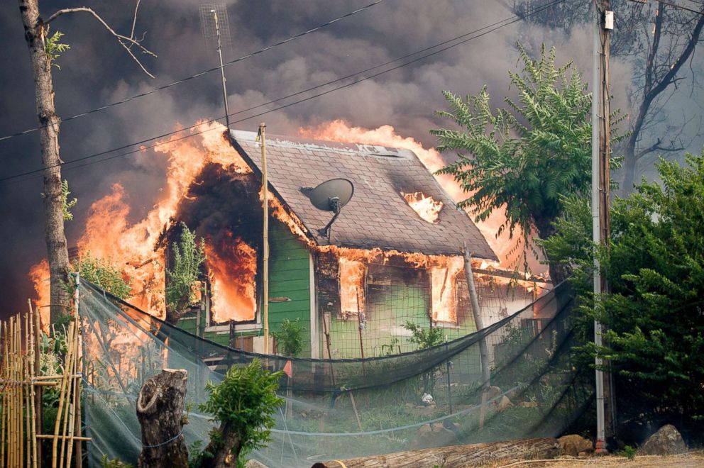 A house burns in the town of Shasta, Calif., after the Carr Fire tore through the town, July 26, 2018.