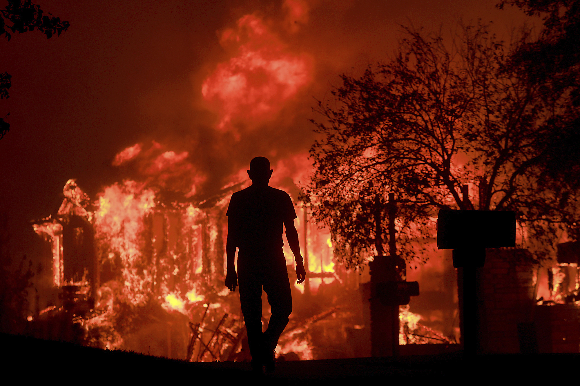 PHOTO: Jim Stites watches part of his neighborhood burn in Fountaingrove, Calif. on Oct. 9, 2017. More than a dozen wildfires have destroyed at least 1,500 homes and businesses and sent thousands of people fleeing.