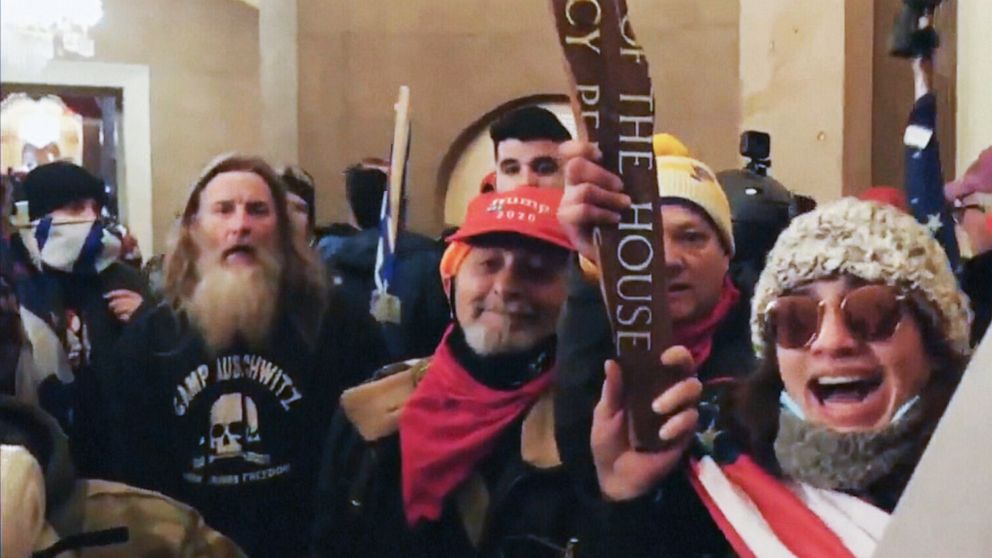 Rioter is seen wearing a ‘Camp Auschwitz’ sweatshirt during the siege of the Capitol among several prisoners