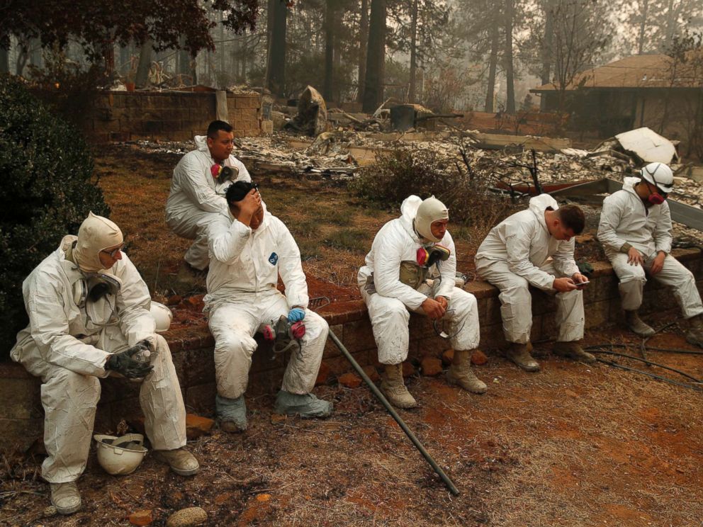 PHOTO: Members of the California Army National Guard take a break at they search burned homes for human remains at the Camp Fire, Nov. 15, 2018, in Paradise, Calif.