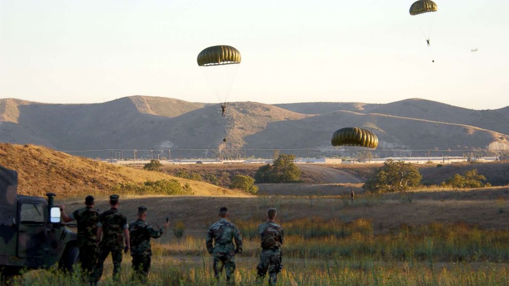 Soldiers parachute from a helicopter during combat readiness training, Sept. 25, 2001 at Camp Pendleton, Calif.