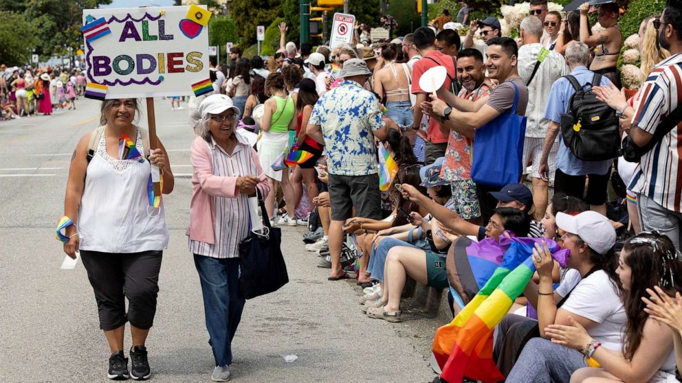 PHOTO: FILE - A participant carries a placard during the Vancouver Pride Parade, Aug. 06, 2023 in Vancouver, Canada.