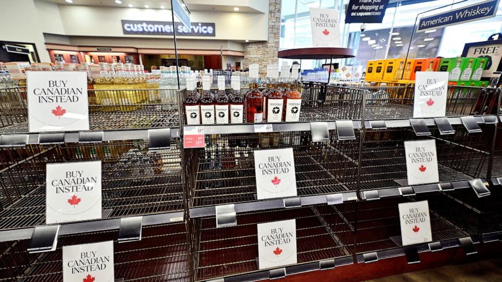 PHOTO: Empty shelves with Buy Canadian Instead signs are seen in the American Whiskey section of the BC Liquor in Vancouver, British Columbia, Canada Mar. 10, 2025.