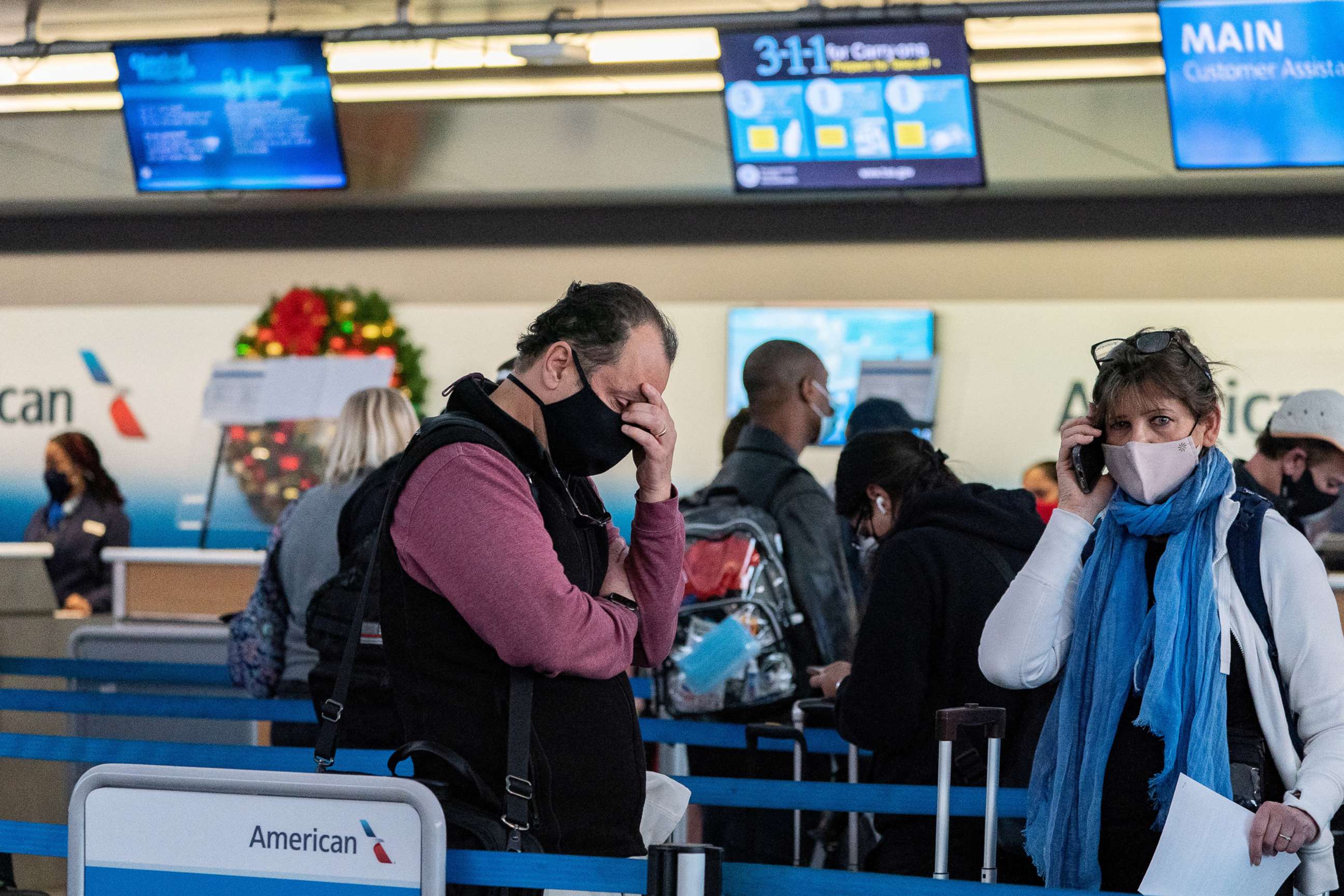 PHOTO: Passengers line up at John F. Kennedy International Airport during the spread of the Omicron coronavirus variant in New York, Dec. 26, 2021. 