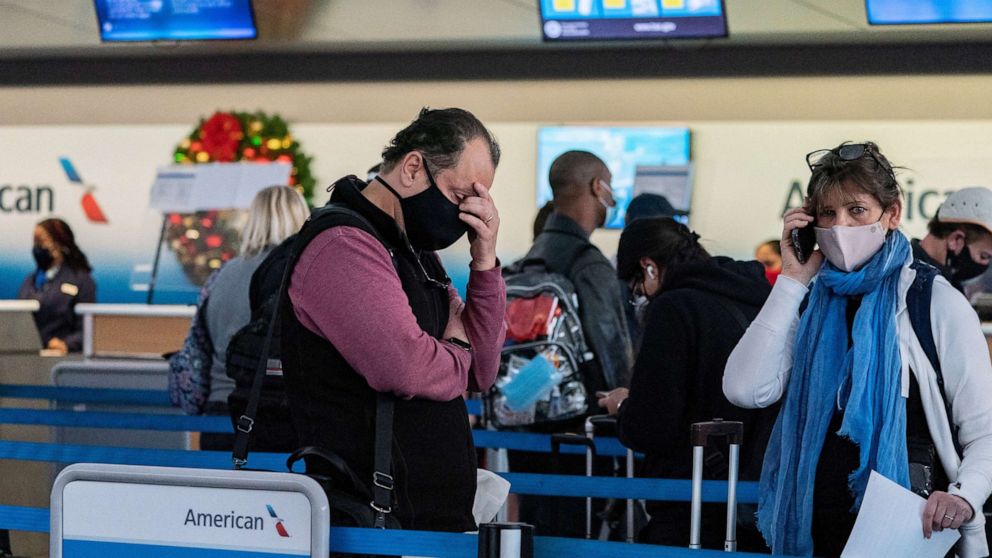 PHOTO: Passengers line up at John F. Kennedy International Airport during the spread of the Omicron coronavirus variant in New York, Dec. 26, 2021. 