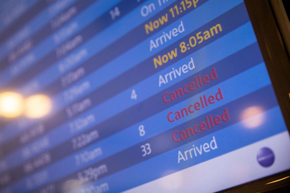 PHOTO: A screen showing cancelled flights is seen at John F. Kennedy International Airport during the spread of the Omicron coronavirus variant in New York, Dec. 26, 2021.