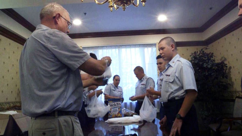 PHOTO: Civil Air Patrol groups now help him get the candy ready, tying the parachutes together in his special way and following his every instruction. Then, Halvorsen boards a helicopter to make his special delivery.