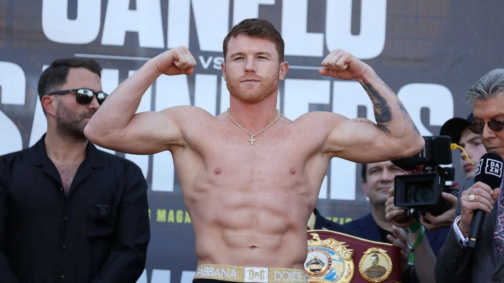 PHOTO: Canelo Alvarez weighs in against Billy Joe Saunders for Alvarez's WBC and WBA super middleweight titles and Saunders' WBO super middleweight title at AT&T Stadium on May 07, 2021, in Arlington, Texas.