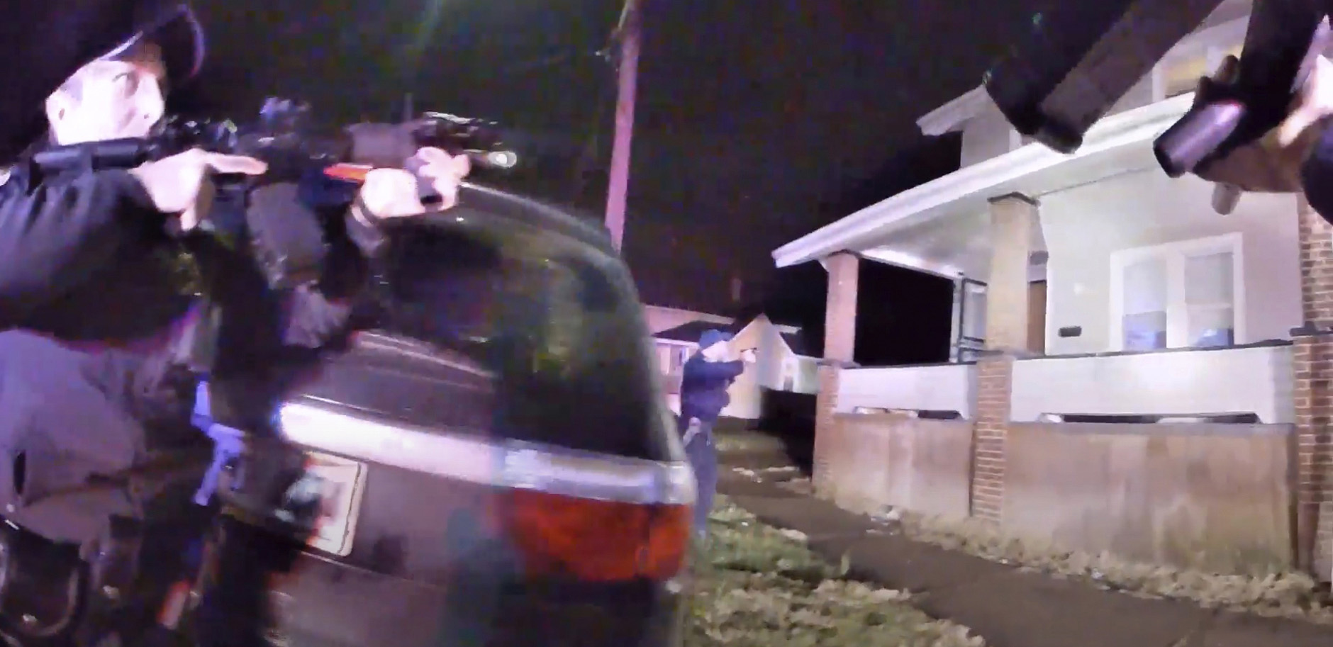 PHOTO: This still image taken from from Canton Police Department body camera video shows officers holding up their weapons before entering a house, Jan. 1, 2022, in Canton, Ohio. 