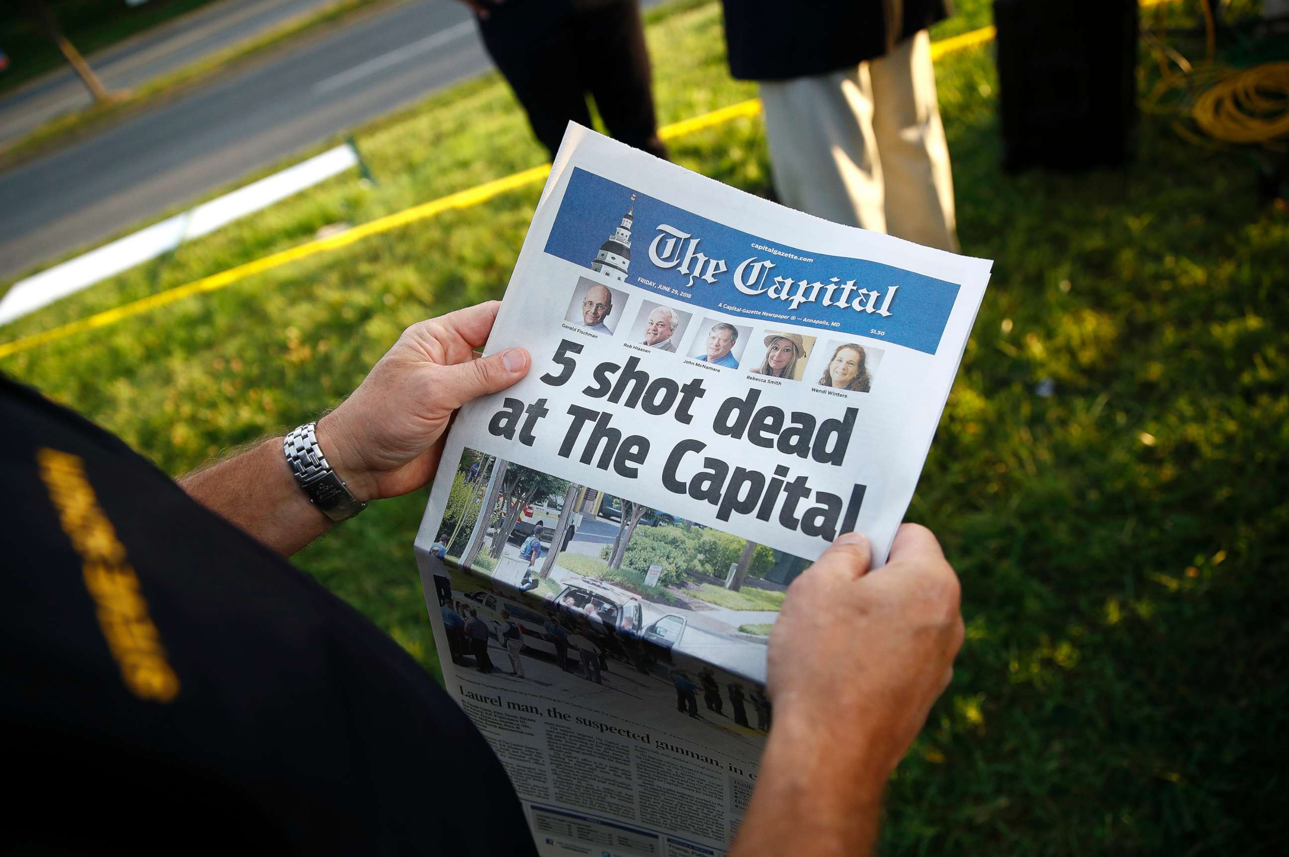 PHOTO: Steve Schuh, county executive of Anne Arundel County, holds a copy of The Capital Gazette near the scene of a shooting at the newspaper's office, June 29, 2018, in Annapolis, Md.