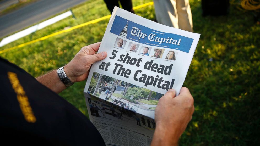 PHOTO: Steve Schuh, county executive of Anne Arundel County, holds a copy of The Capital Gazette near the scene of a shooting at the newspaper's office, June 29, 2018, in Annapolis, Md.