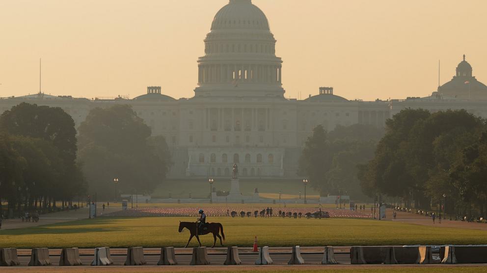 PHOTO: A U.S. Park Police mounted officer rides across the National Mall near the U.S. Capitol at dawn, June 12, 2025 in Washington.