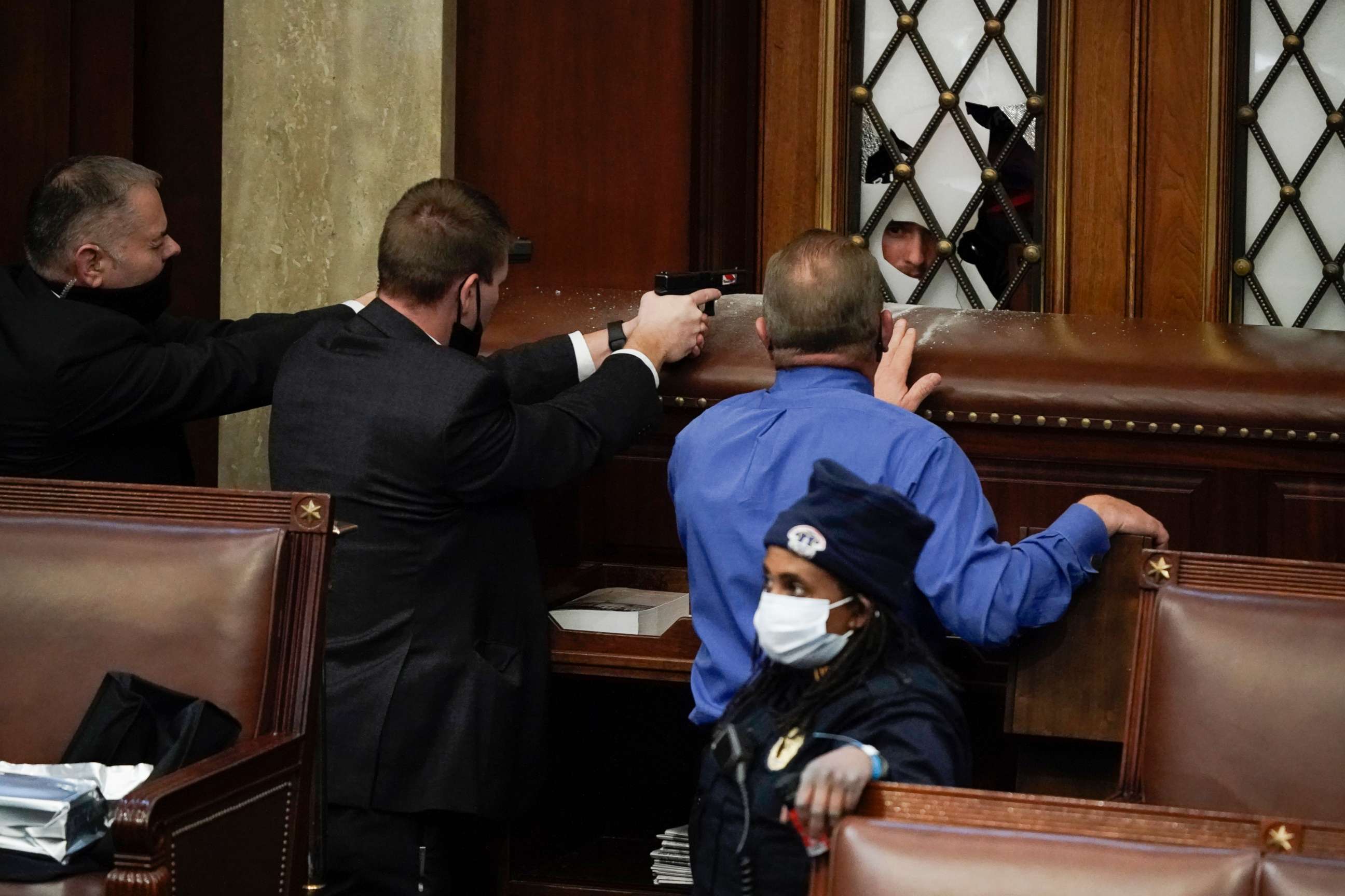 PHOTO: Police with guns drawn watch as protesters try to break into the House Chamber at the U.S. Capitol, Jan. 6, 2021, in Washington.