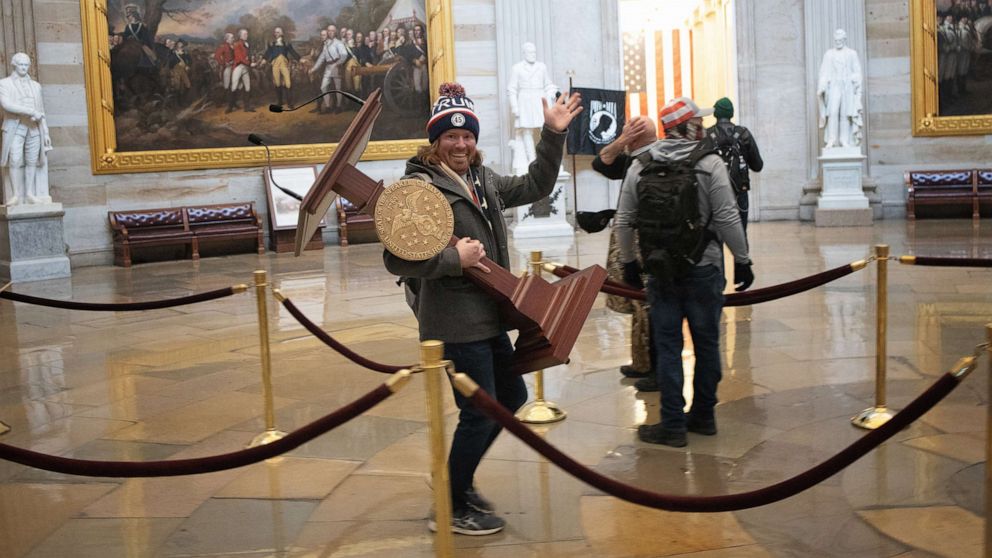 PHOTO: A pro-Trump rioter carries the lectern of Speaker of the House Nancy Pelosi through the Roturnda of the U.S. Capitol Building after a pro-Trump mob stormed the building, Jan. 6, 2021, in Washington, DC.