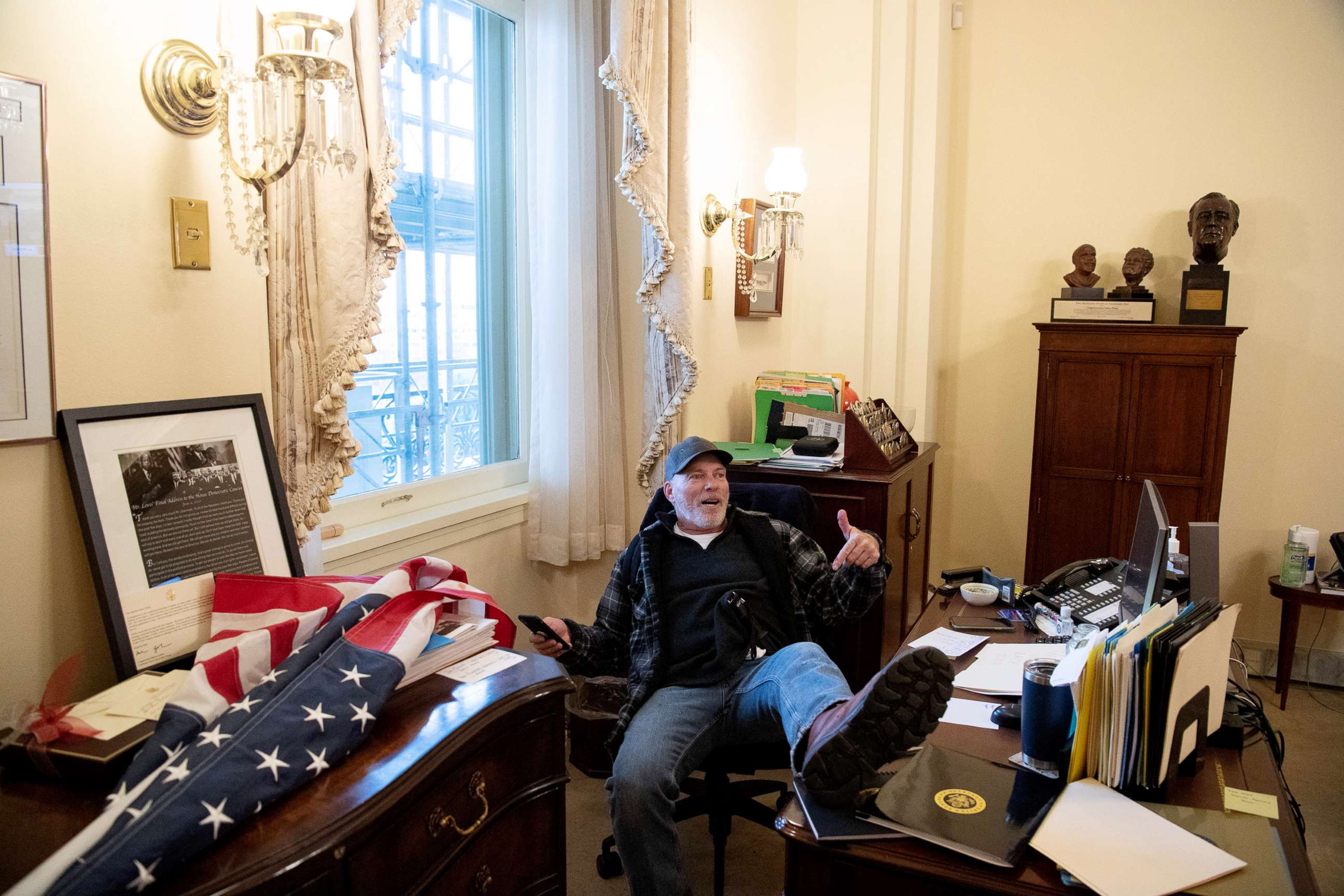 PHOTO: Richard Barnett, a supporter of US President Donald Trump sits inside the office of US Speaker of the House Nancy Pelosi as he protest inside the US Capitol, Jan. 6, 2021. 
