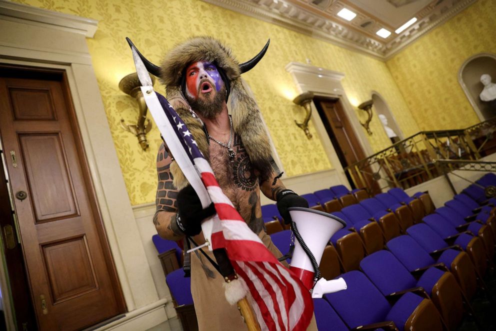PHOTO: Protester Jacob Chansley screams "Freedom" inside the Senate chamber after the U.S. Capitol was breached by a pro-Trump mob during a joint session of Congress on Jan. 06, 2021 .