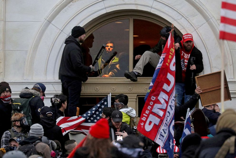 PHOTO: A mob of supporters of then-U.S. President Donald Trump climb through a window they broke as they storm the Capitol Building, Jan. 6, 2021.