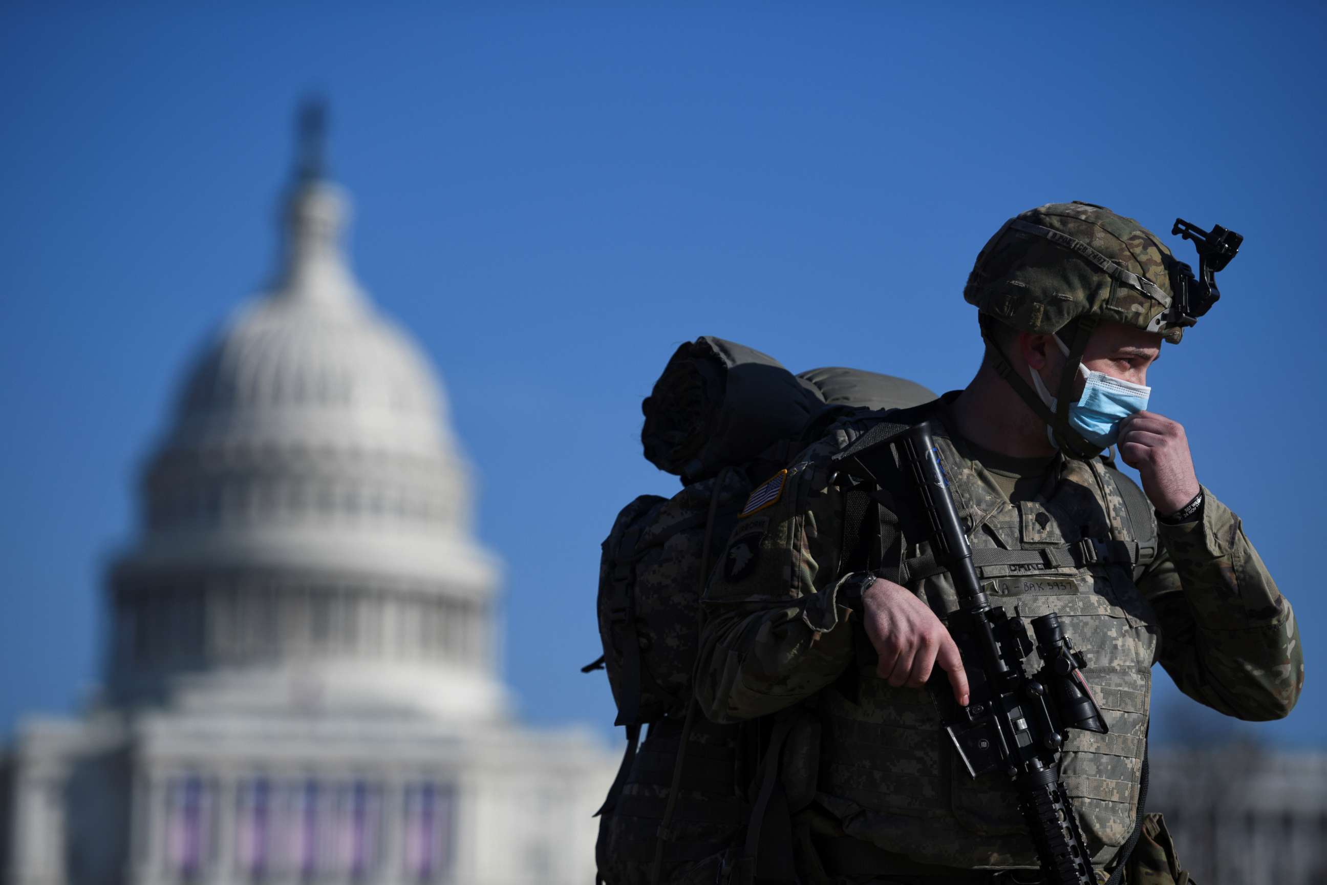 PHOTO: A member of the National Guard adjusts his protective mask near the Capitol building in Washington, Jan. 13, 2021.