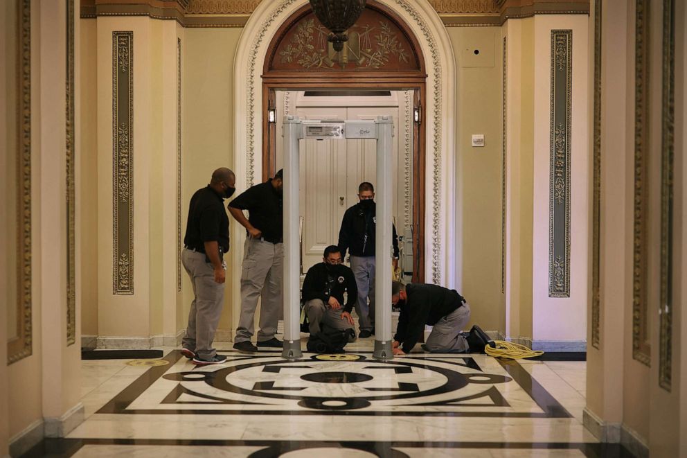 PHOTO: U.S. Capitol Police install a metal detector outside the House of Representatives Chamber, Jan. 12, 2021 in Washington, DC.