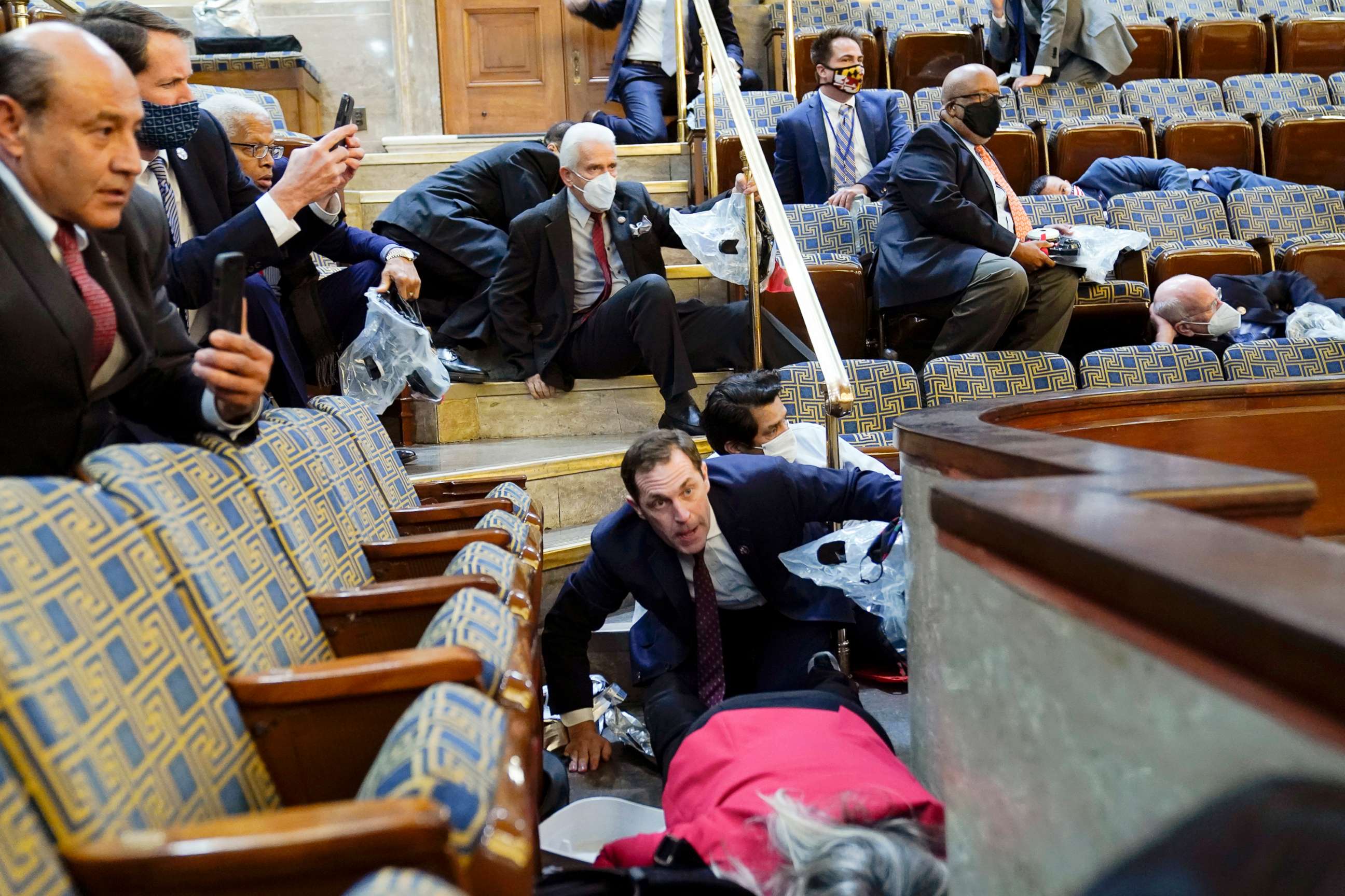 PHOTO: People shelter in the House gallery as rioters try to break into the House Chamber at the U.S. Capitol, Jan. 6, 2021, in Washington.