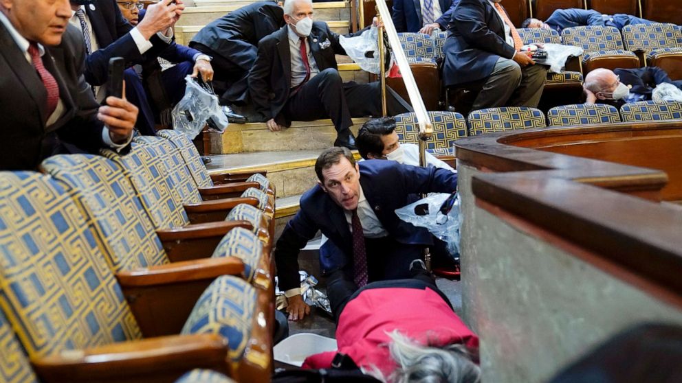 PHOTO: People shelter in the House gallery as rioters try to break into the House Chamber at the U.S. Capitol, Jan. 6, 2021, in Washington.