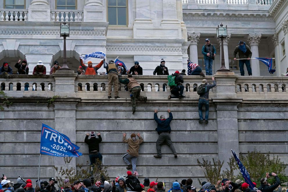 PHOTO: Supporters of President Donald Trump climb the west wall of the the U.S. Capitol in Washington as they try to storm the building on Jan. 6, 2021, while inside Congress prepared to affirm President-elect Joe Biden's election victory.