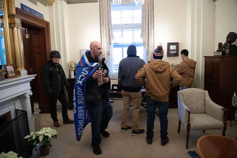 PHOTO: Supporters of President Donald Trump walk through the office suite of Speaker of the House Nancy Pelosi after breaching the US Capitol in Washington, D.C., Jan. 6, 2021.