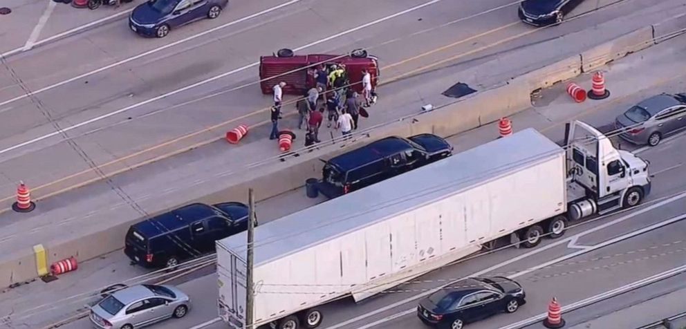 PHOTO: Good Samaritans rescue a driver after a pickup flips on the highway in Oak Brook, Ill. , July 22, 2019.