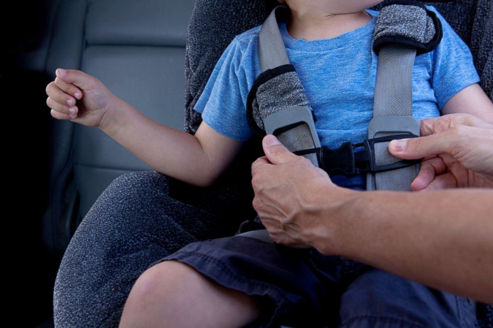 PHOTO: A parent fasten a child on a car seat in this undated stock photo.