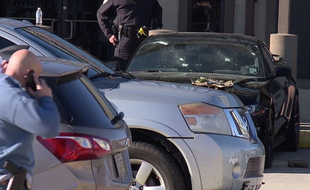 PHOTO: Bullet holes are seen in the front windshield of a car parked at Jefferson Gun Shop in Metairie, La., where three people were killed on Feb. 20, 2021.