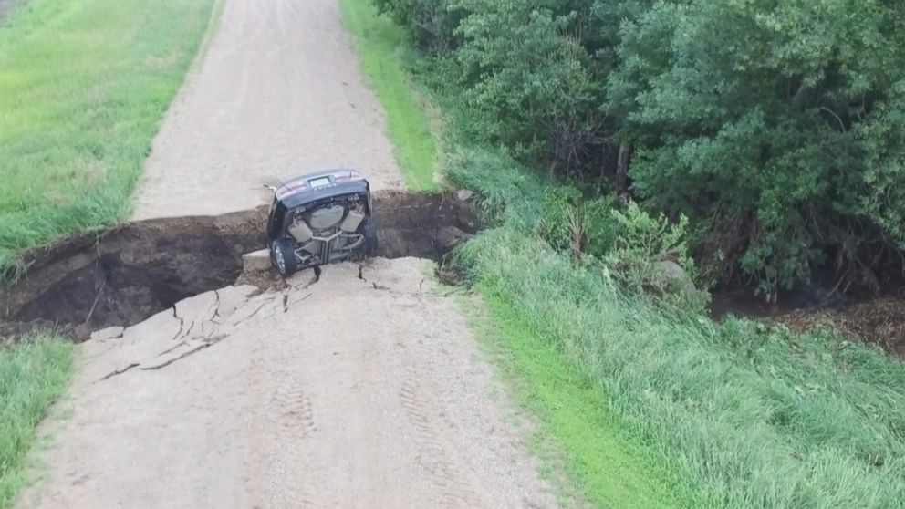 PHOTO: A teen drives car into sinkhole and escapes injury free, in Renville Minnesota, July 3, 2018.