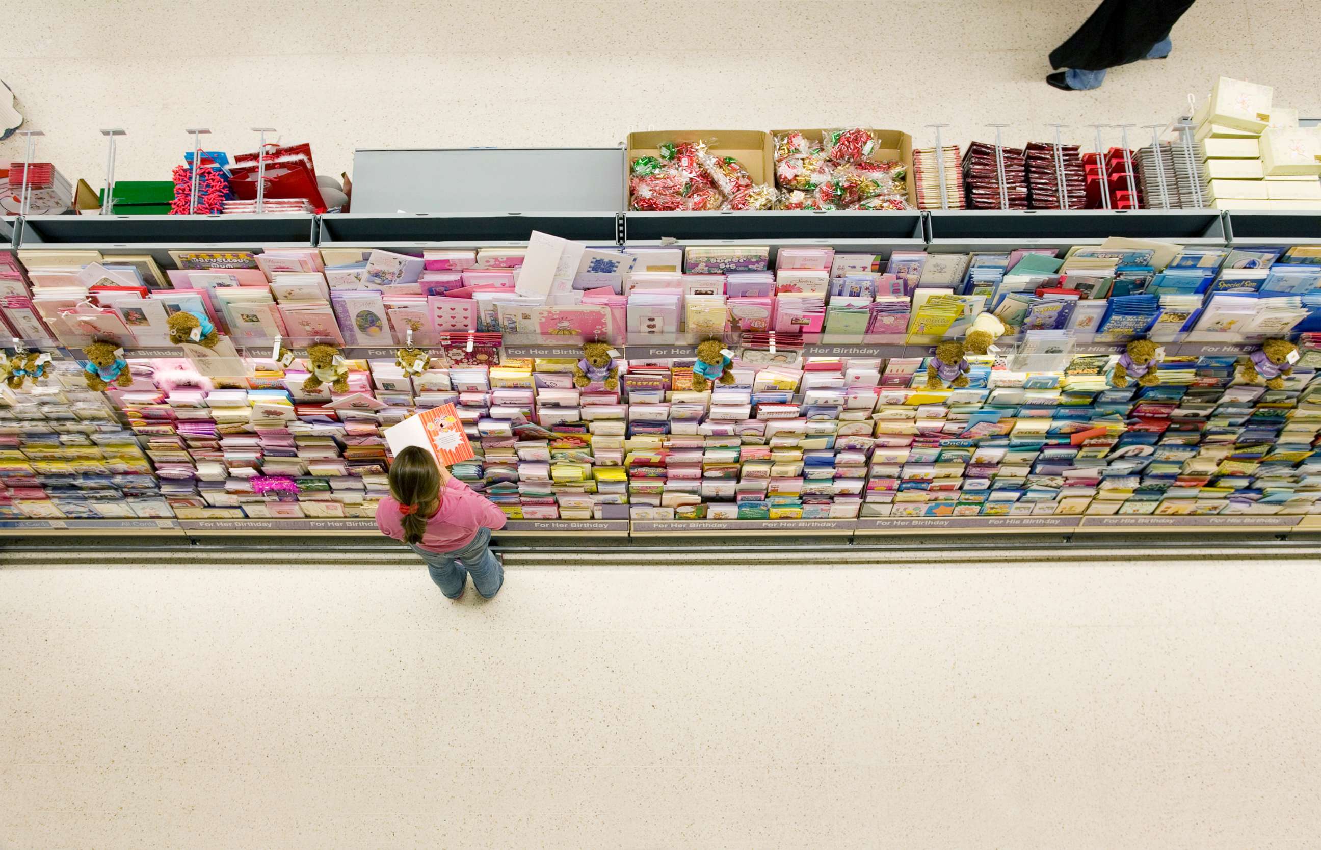 PHOTO: A girl looks at greeting cards in a store. 