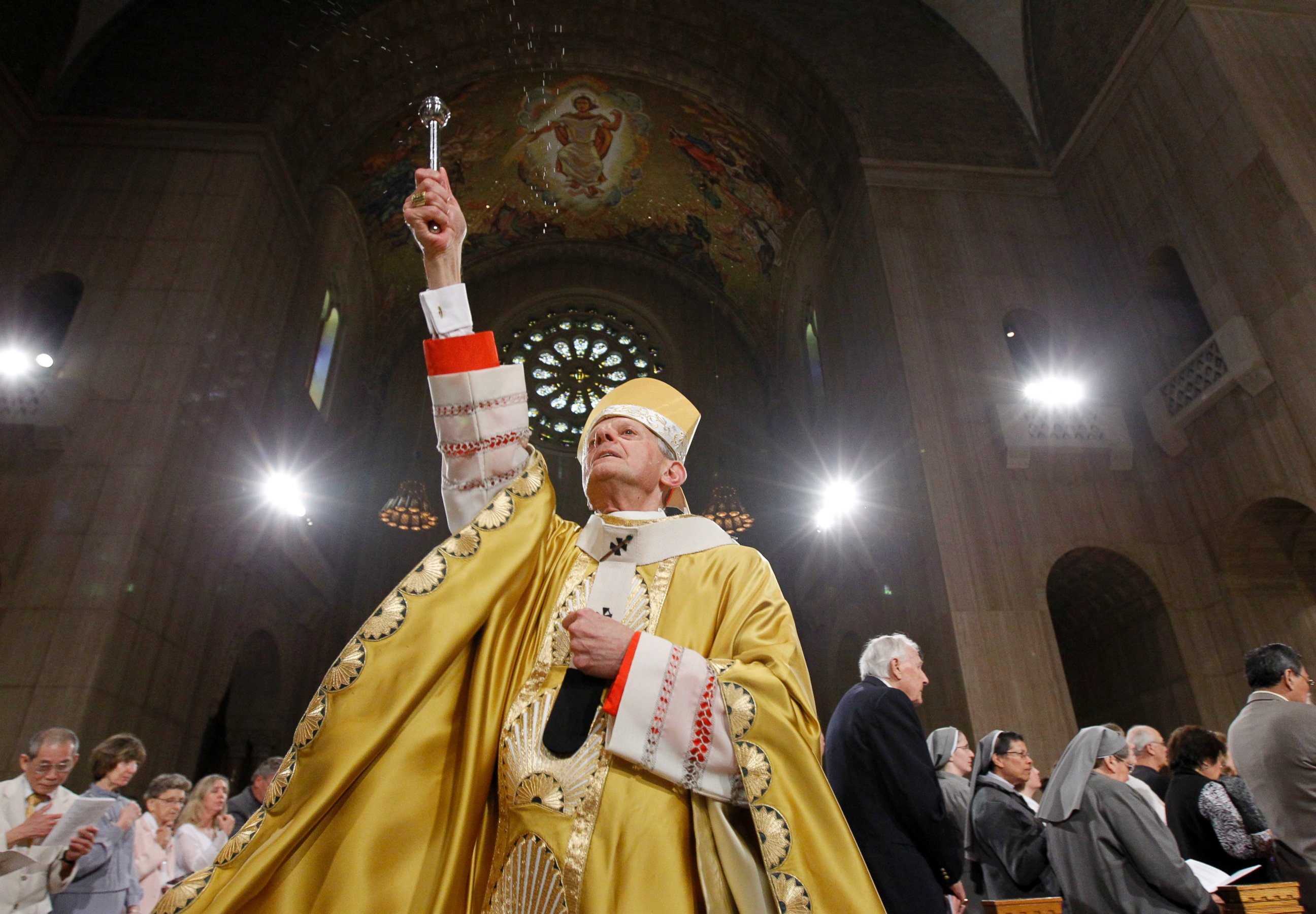 In this Sunday, April 24, 2011 file photo, Cardinal Donald Wuerl, Archbishop of Washington, sprinkles Holy Water during Easter Mass at the Basilica of the National Shrine of the Immaculate Conception Roman Catholic Church in Washington. 