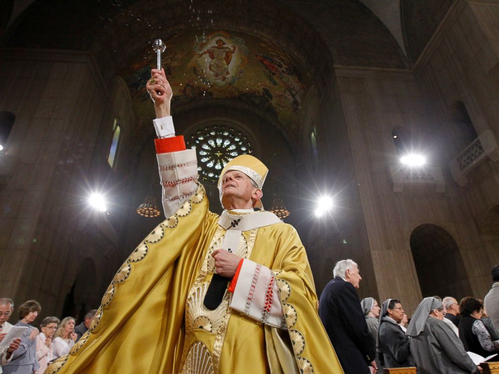 In this Sunday, April 24, 2011 file photo, Cardinal Donald Wuerl, Archbishop of Washington, sprinkles Holy Water during Easter Mass at the Basilica of the National Shrine of the Immaculate Conception Roman Catholic Church in Washington.