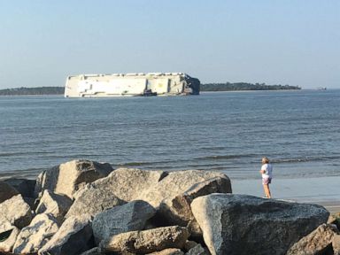 Rescue teams make contact with crew members inside capsized cargo ship