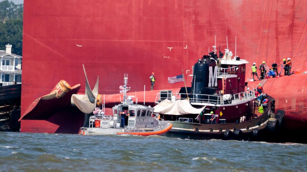 PHOTO: Rescuers work near the stern of the vessel Golden Ray as it lays on its side near the Moran tug boat Dorothy Moran, Monday, Sept. 9, 2019, in Jekyll Island, Ga.