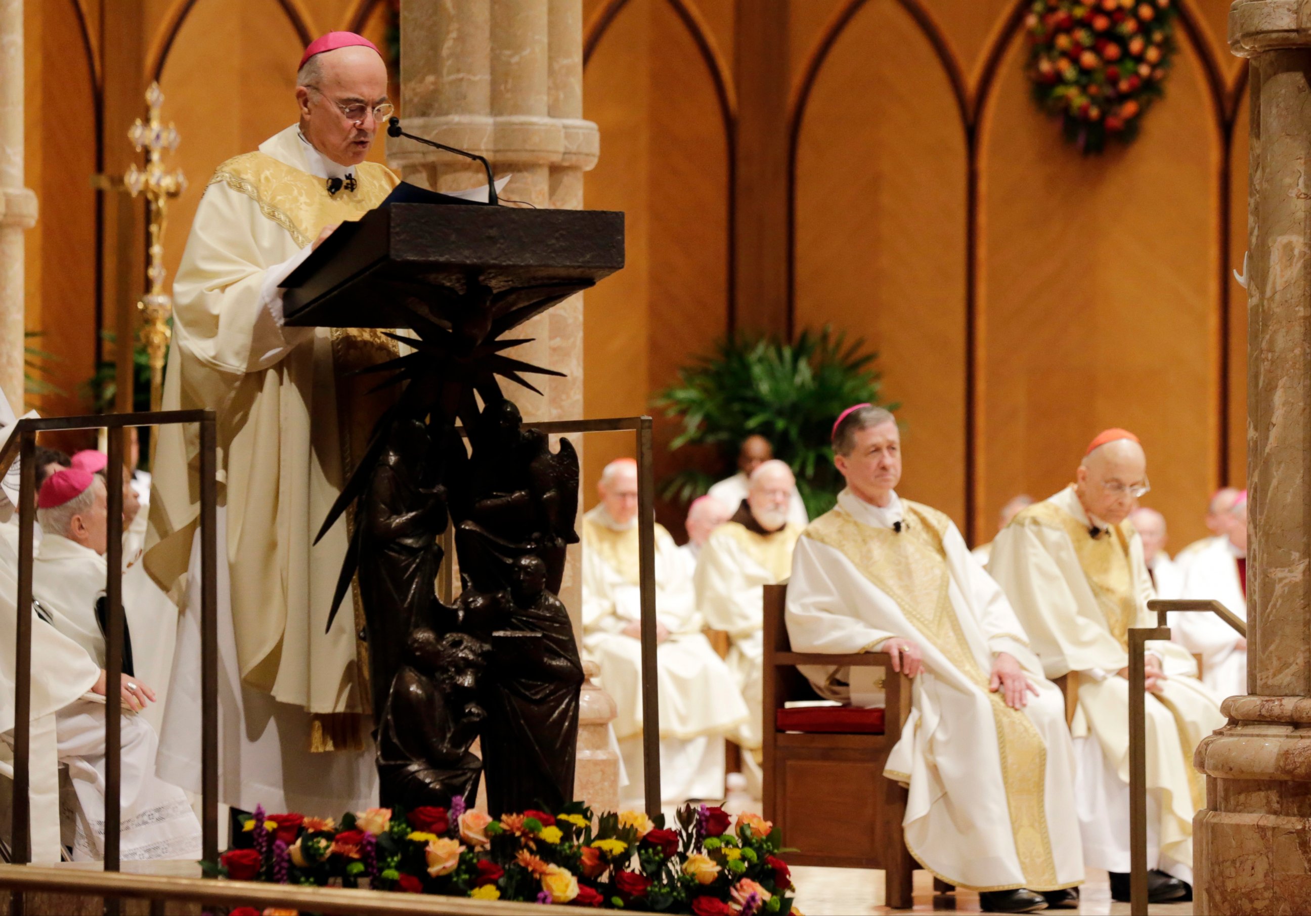 In this Nov. 18, 2014 file photo, Archbishop Carlo Maria ViganÃ² reads the Apostolic Mandate during the Installation Mass of Archbishop Blase Cupich at Holy Name Cathedral, in Chicago. 