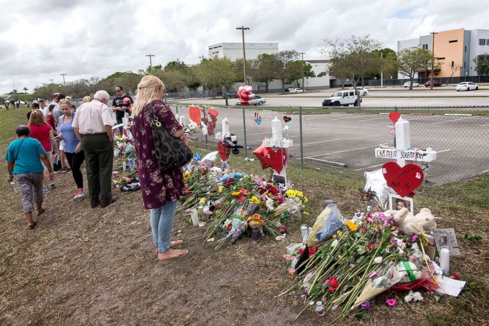 PHOTO: People visit a makeshift memorial in front of the Marjory Stoneman Douglas High School in, Parkland, Fls, Feb. 20, 2018. 