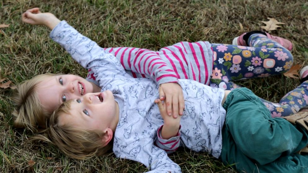 PHOTO: Lucy and Arlo Carmichael play outside their home in Milton, Vermont.