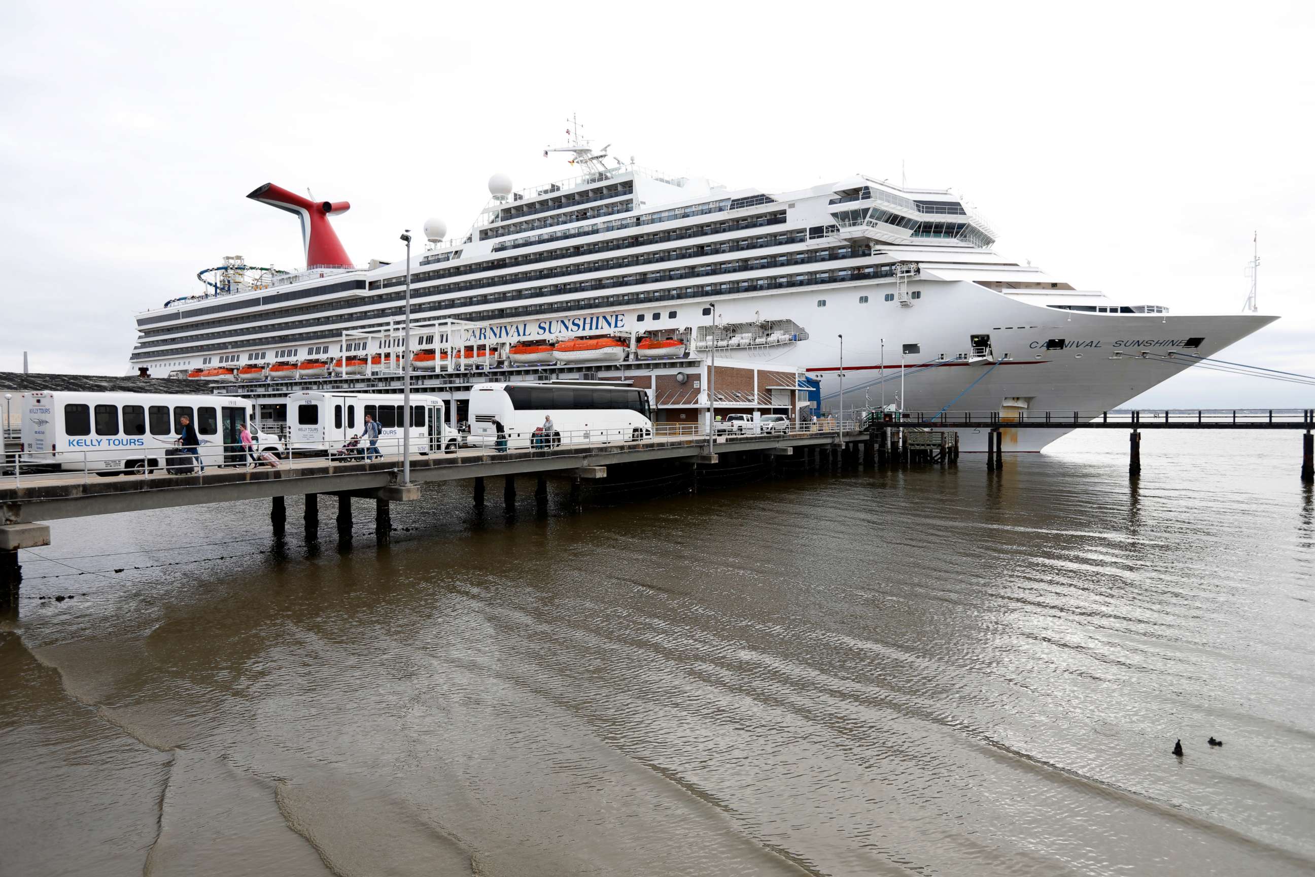 PHOTO: FILE - Passengers disembark from the Carnival Sunshine cruise ship on March 16, 2020, in Charleston, S.C.