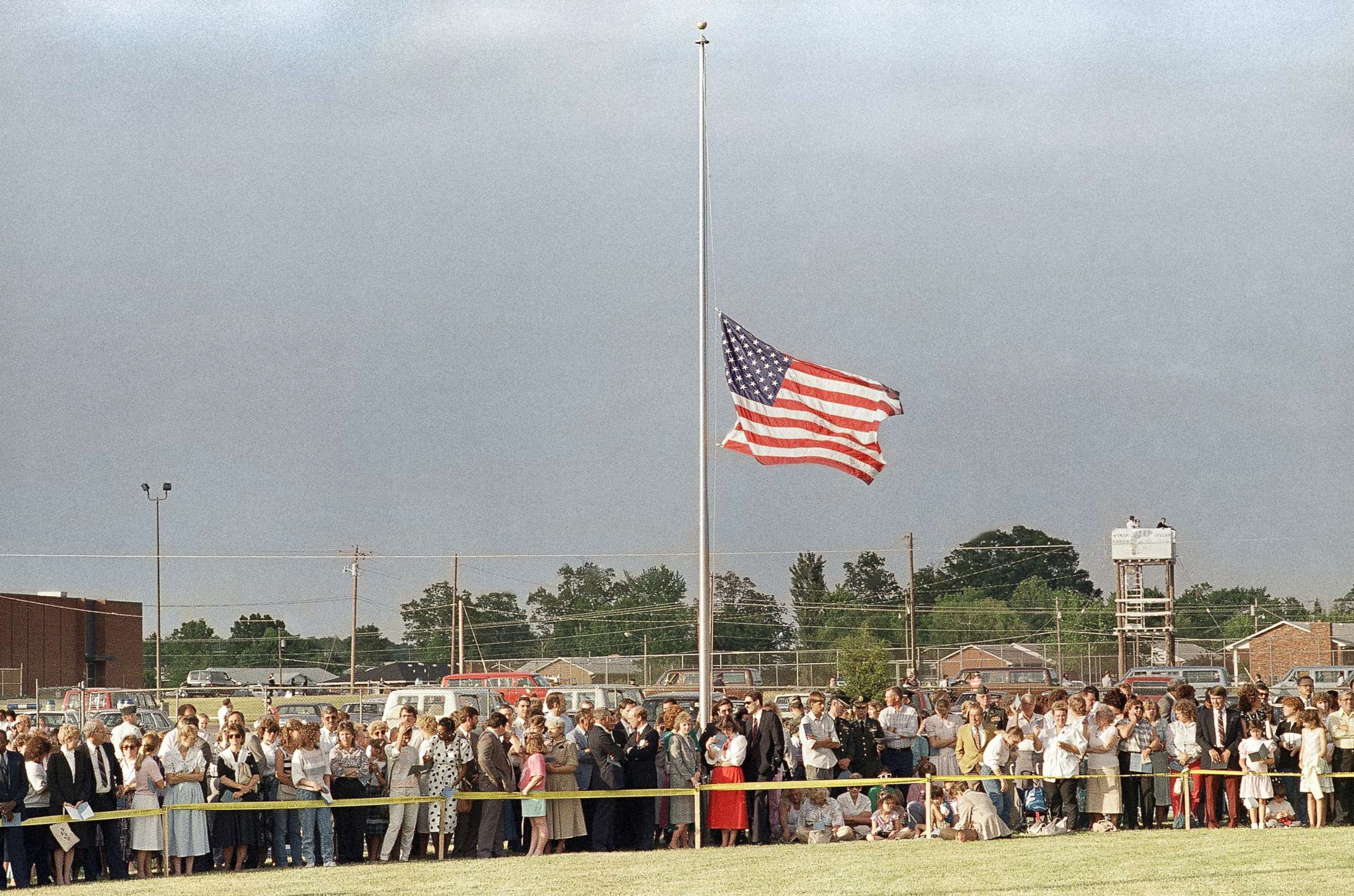 PHOTO: The American flag flies at half must during a memorial service attended by thousands at the North Hardin School football stadium in Radcliff, Ky. on May 19, 1988, in honor of the 27 people killed in a bus accident near Carrollton.