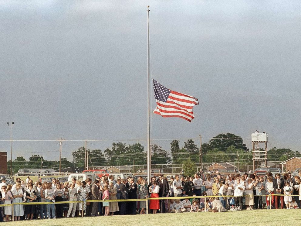 PHOTO: The American flag flies at half must during a memorial service attended by thousands at the North Hardin School football stadium in Radcliff, Ky. on May 19, 1988, in honor of the 27 people killed in a bus accident near Carrollton.